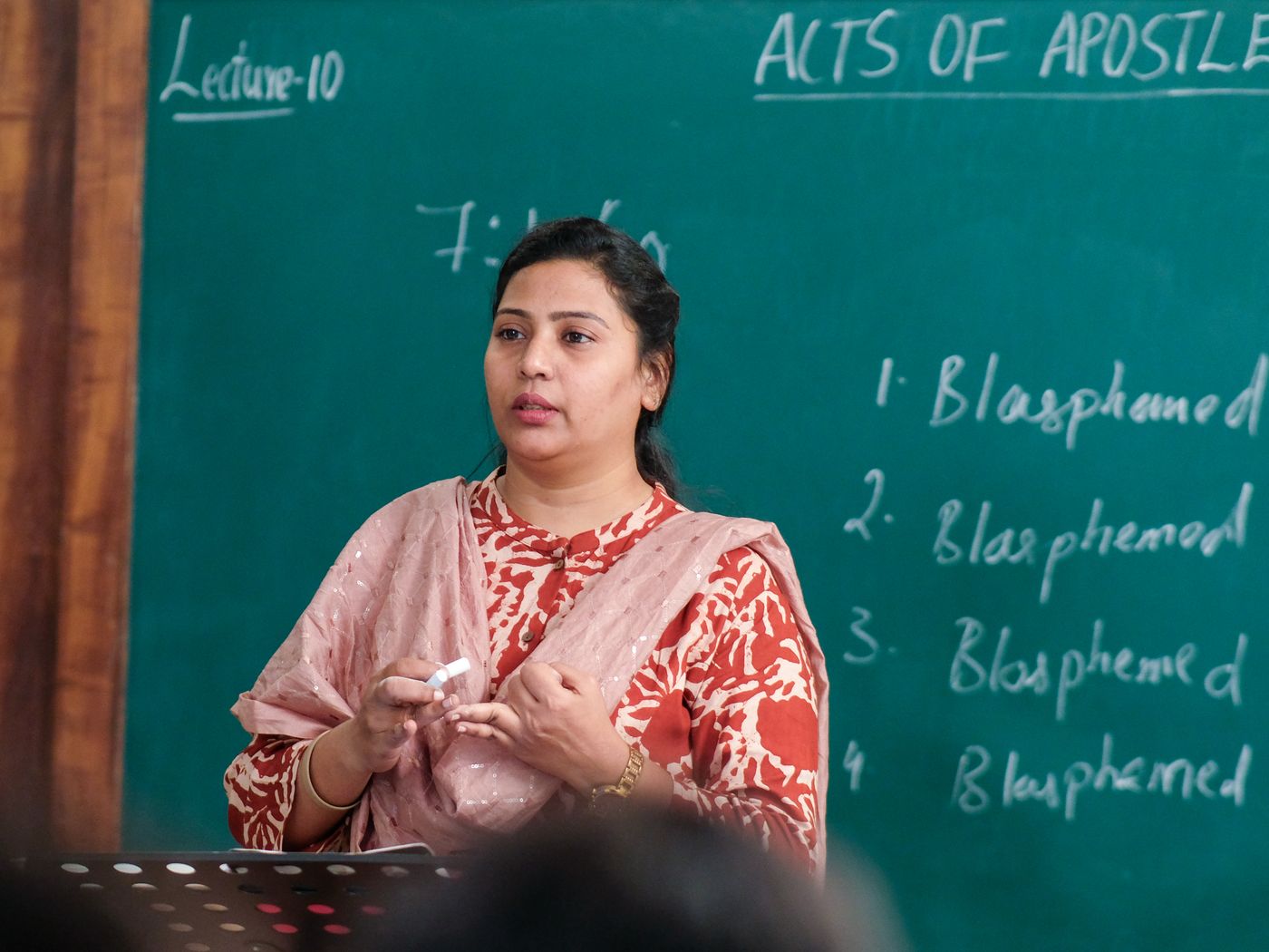 A lecturer teaching students in a classroom