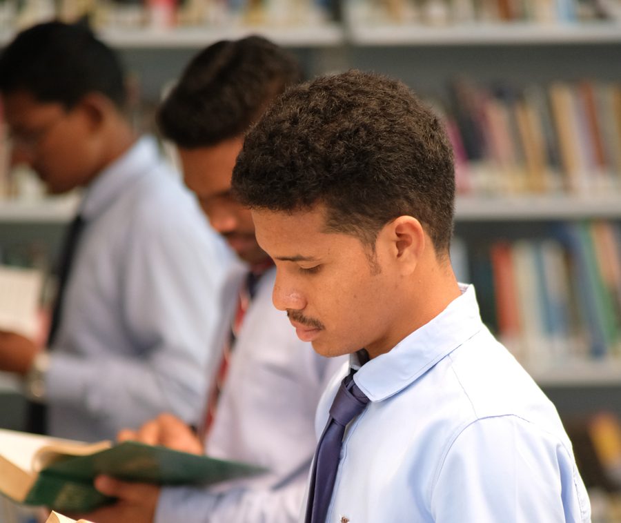 Students reading in the STARR Library stacks